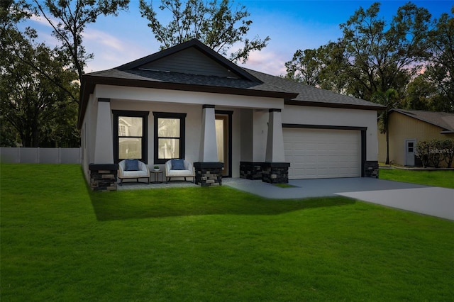 view of front of property with a yard and a garage