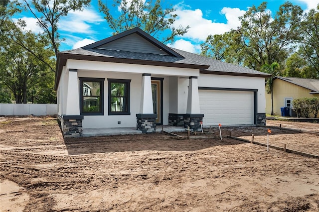 view of front of home featuring covered porch and a garage