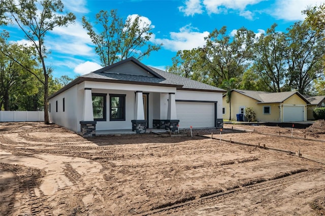 view of front facade with covered porch and a garage