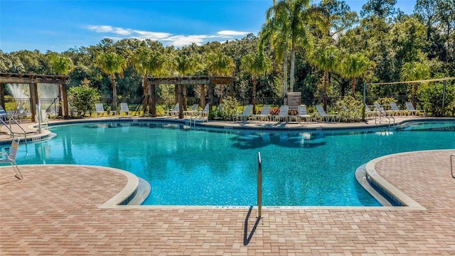 community pool with fence and a pergola