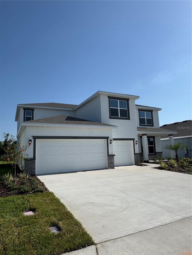 view of front of house featuring stucco siding, concrete driveway, stone siding, and a garage