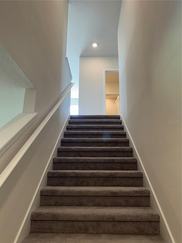 stairway featuring recessed lighting and baseboards