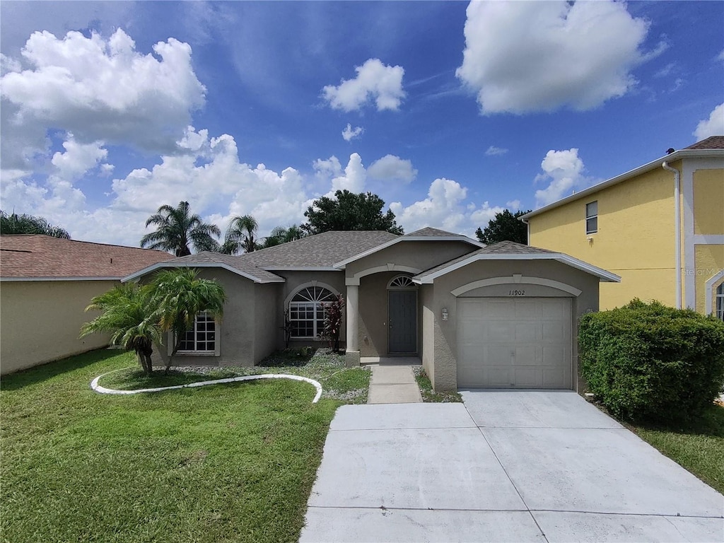 view of front of house featuring a garage and a front lawn