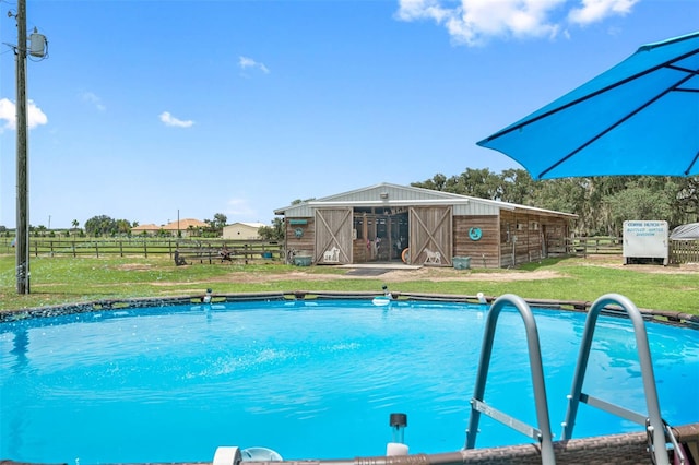 view of pool featuring an outbuilding and a lawn