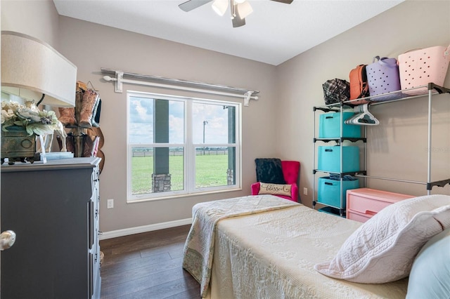 bedroom featuring a ceiling fan, baseboards, and wood finished floors