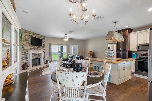 kitchen with wood counters, visible vents, stainless steel appliances, and open floor plan