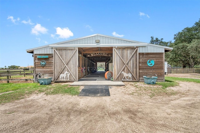 view of outdoor structure featuring an outbuilding, an exterior structure, and fence