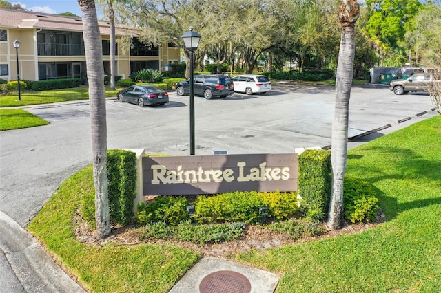 community sign featuring a lawn