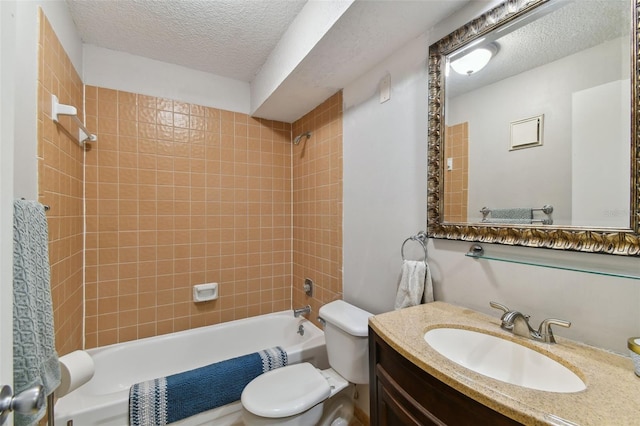 full bathroom featuring vanity, a textured ceiling, tiled shower / bath combo, and toilet