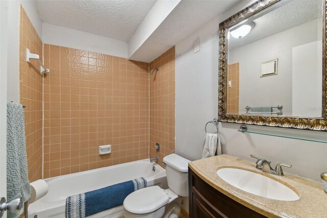 full bath featuring a textured ceiling,  shower combination, vanity, and toilet