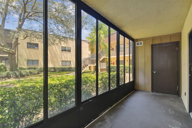 unfurnished sunroom with visible vents