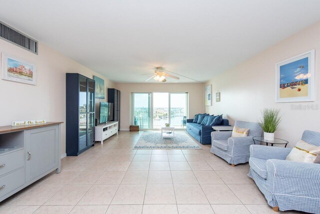 tiled living room with ceiling fan