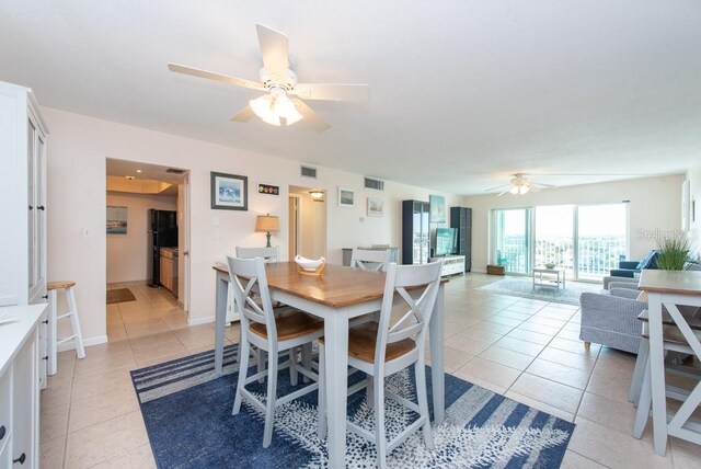 dining area featuring ceiling fan and light tile patterned flooring