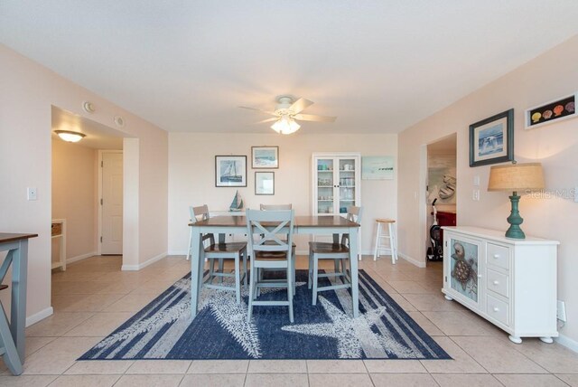 tiled dining area with ceiling fan