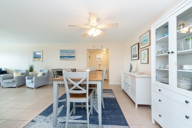 dining room with ceiling fan and light tile patterned flooring