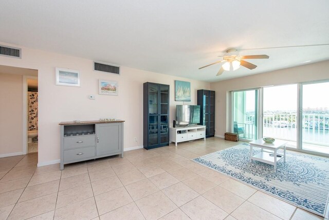 tiled living room with ceiling fan