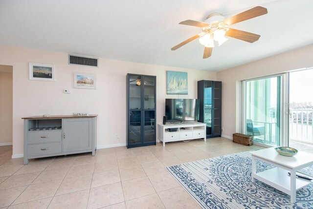 living room featuring ceiling fan and light tile patterned floors