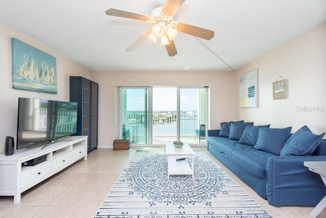 living room featuring ceiling fan and light tile patterned floors