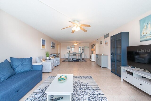 tiled living room with ceiling fan