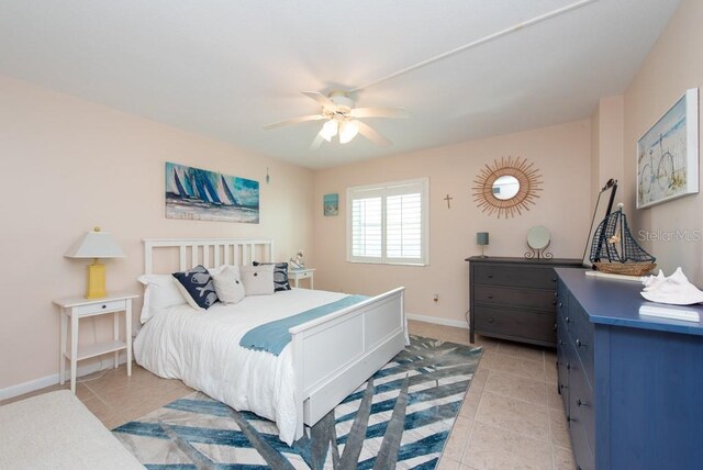 tiled bedroom featuring ceiling fan