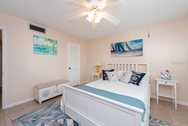 bedroom with ceiling fan, a closet, and light tile patterned flooring