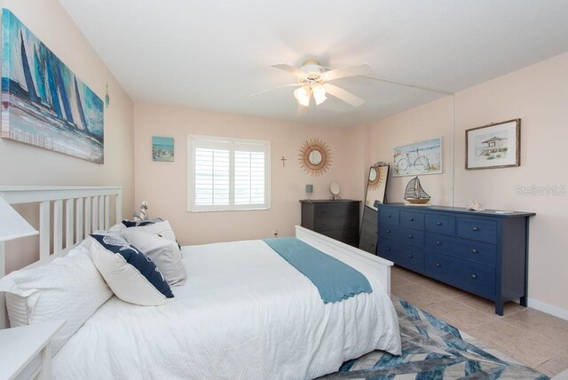 bedroom with ceiling fan and light tile patterned floors