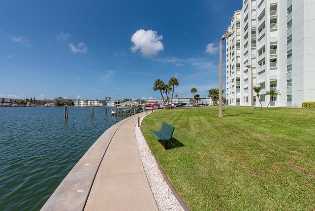 view of community with a lawn and a water view