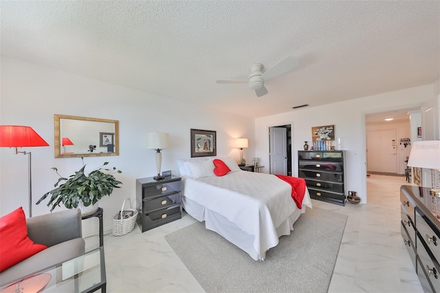 bedroom featuring a textured ceiling and ceiling fan