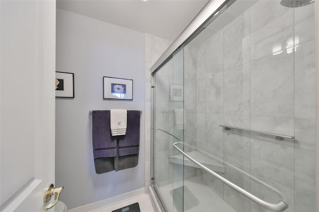 bathroom with tile patterned flooring and a shower with door