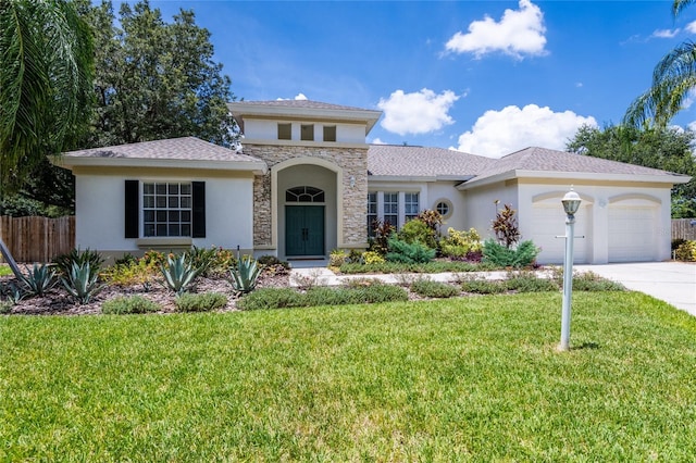 mediterranean / spanish-style home with a garage and a front yard