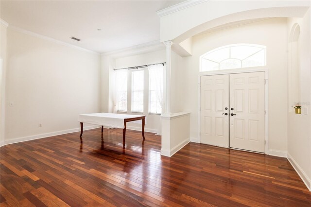 entrance foyer featuring a healthy amount of sunlight, crown molding, hardwood / wood-style floors, and decorative columns