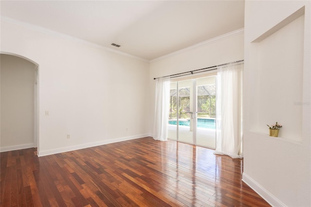 empty room featuring crown molding and hardwood / wood-style floors