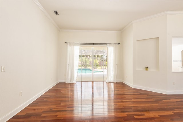 empty room with crown molding and dark wood-type flooring