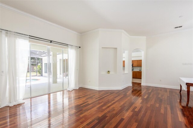 unfurnished room featuring ornamental molding and dark wood-type flooring