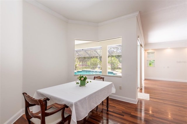 dining room with hardwood / wood-style flooring and crown molding