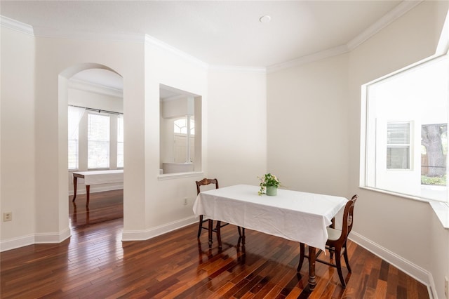 dining area featuring ornamental molding and dark hardwood / wood-style flooring