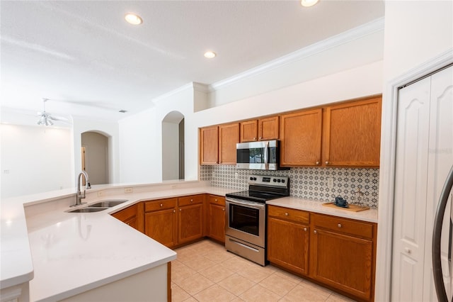 kitchen with stainless steel appliances, sink, kitchen peninsula, light tile patterned floors, and decorative backsplash