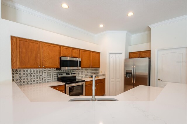 kitchen featuring ornamental molding, sink, tasteful backsplash, and stainless steel appliances