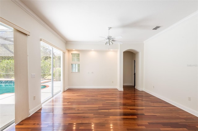 empty room with ornamental molding, dark wood-type flooring, and ceiling fan