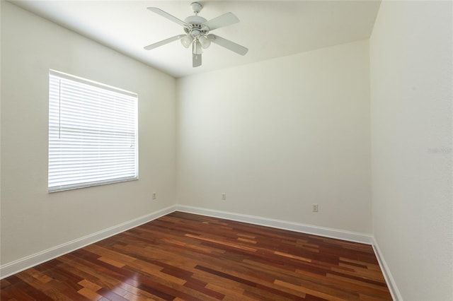 empty room with dark wood-type flooring and ceiling fan