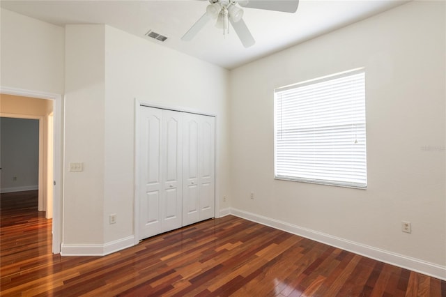 unfurnished bedroom with a closet, wood-type flooring, and ceiling fan