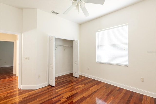 unfurnished bedroom featuring wood-type flooring, a closet, and ceiling fan