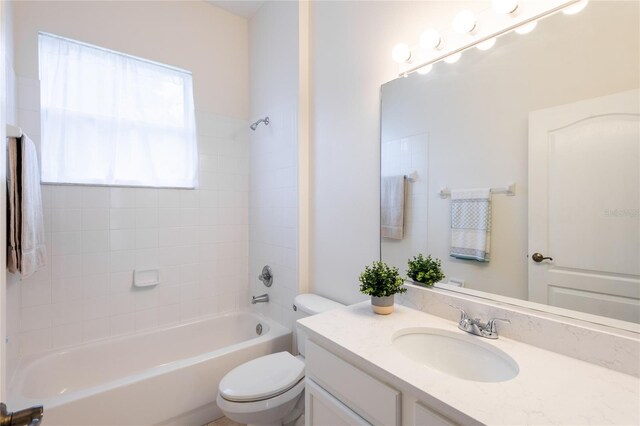 full bathroom with vanity, toilet, and tiled shower / bath