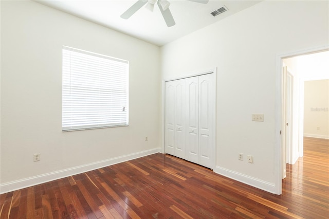 unfurnished bedroom with a closet, hardwood / wood-style flooring, and ceiling fan