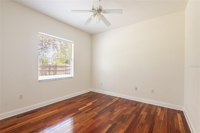 empty room featuring ceiling fan and dark hardwood / wood-style flooring