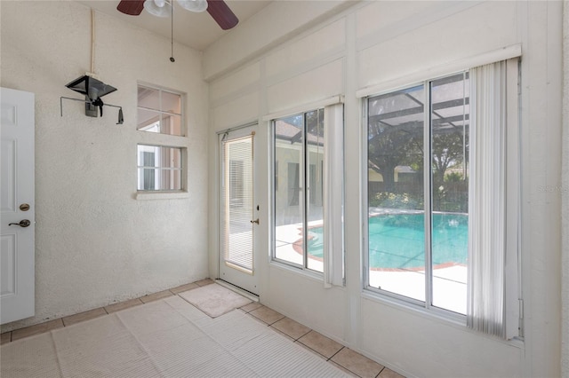 entryway with light tile patterned floors and ceiling fan