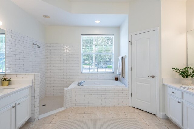 bathroom featuring tiled shower, vanity, and tile patterned floors