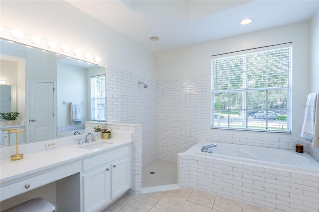 bathroom with tile patterned floors, vanity, and a wealth of natural light