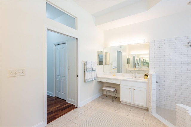 bathroom featuring a shower, vanity, and tile patterned floors