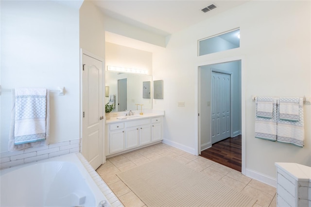 bathroom featuring wood-type flooring, vanity, and a bathtub